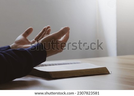 Man hand worship God and read the Bible.Christian concept. Mission of God.Bible learning and faith in God.