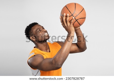 Confident smiling  African American basketball player holding ball isolated on white background. Sport, healthy lifestyle, competition concept 	
