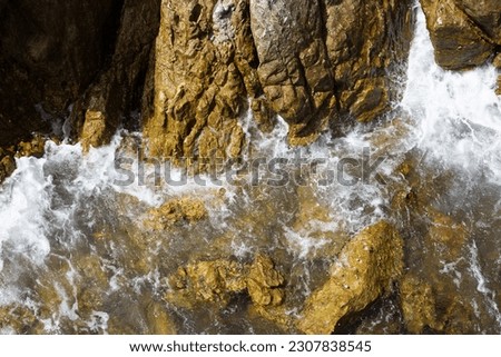 Sea water splashing on rocks