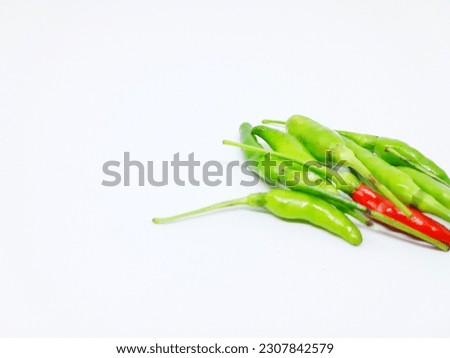 Red and green colored chili peppers isolated on white background