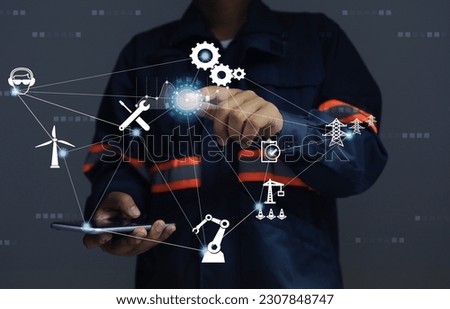 Engineers analysis order turn on, turn off, control and check machine status online by using application via smartphone. Smart Factory, Remote Control or Digital Facility Management Concept. Royalty-Free Stock Photo #2307848747