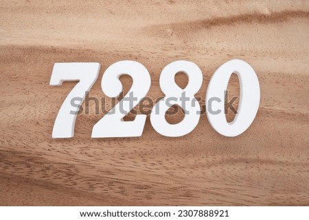 White number 7280 on a brown and light brown wooden background.