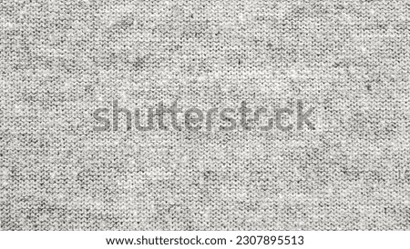 Close up gray cotton heather texture background.  
Black and white texture knit fabric pattern seamless.
Selective focus.
top view. Royalty-Free Stock Photo #2307895513