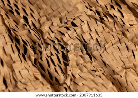 Decorative craft paper with cuts for packaging and decoration, decorative paper close-up is used to decorate flowers and other gifts Royalty-Free Stock Photo #2307911635