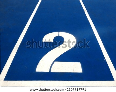 Stadium runway or athlete's track start number (2). Tracks are rubber man-made tracks used in athletics. Royalty-Free Stock Photo #2307919791