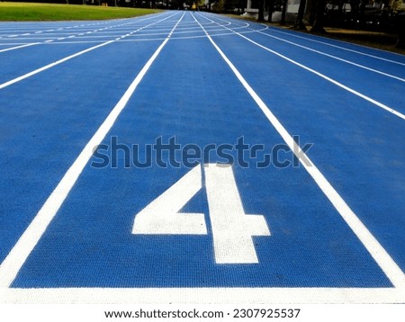 Stadium runway or athlete's track start number (4). Tracks are rubber man-made tracks used in athletics. Royalty-Free Stock Photo #2307925537