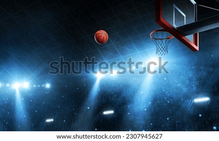 the moment when the basketball flies through the air towards the hoop Royalty-Free Stock Photo #2307945627
