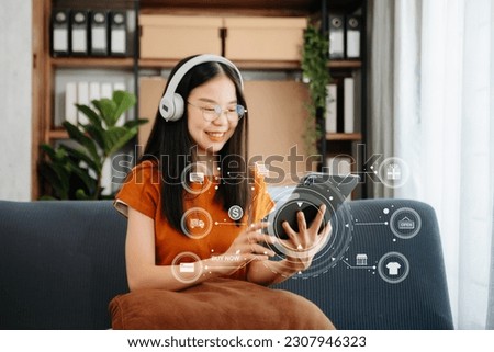  Asian Woman Hand using tablet ,laptop, and holding mobile phone with credit card online banking payment communication network, internet application virtual icon 
