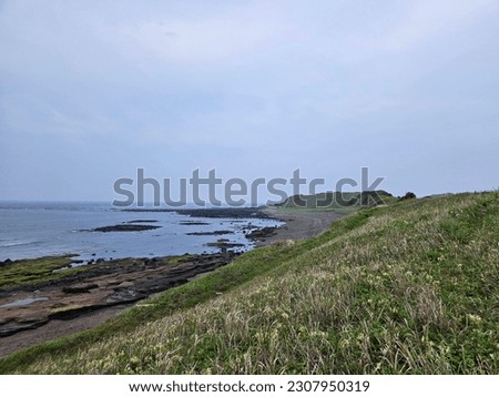 It is a picture of the scenery of Jeju Island, beautiful island, and the sea and sky and mountains from Jeju Island.