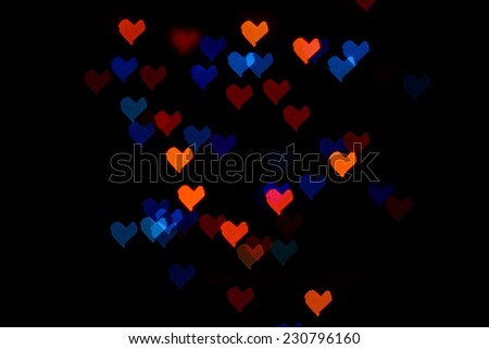 Multicolored abstract background of lights in the form of the heart is not in focus