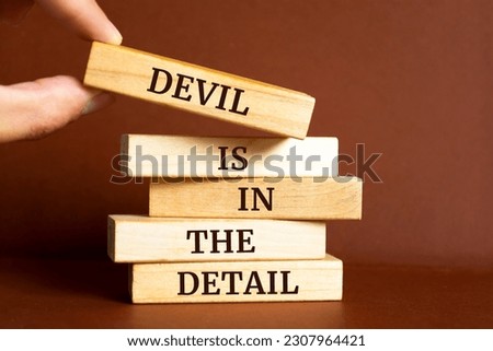 Wooden blocks with words 'Devil is in the detail'.