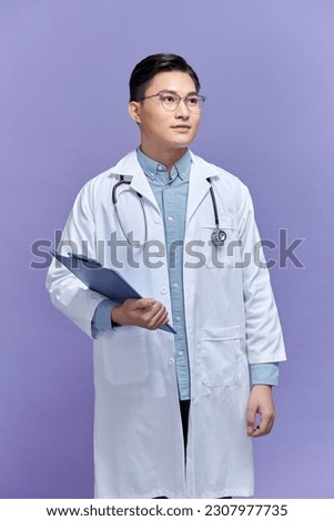 Waist up portrait view of the confident doctor in a uniform and in glasses holding folder with serious face Royalty-Free Stock Photo #2307977735