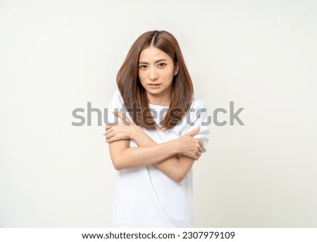 Young asian woman feel cold. Frozen Winter season. Hug herself warming up temperature. Female trembles Feel bad and suffer Royalty-Free Stock Photo #2307979109