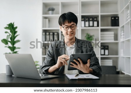 Young business man executive manager looking at laptop watching online webinar training or having virtual meeting video conference doing market research working in modern office.

