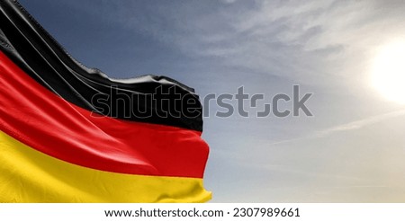 Germany national flag cloth fabric waving on beautiful grey sky Background. Royalty-Free Stock Photo #2307989661