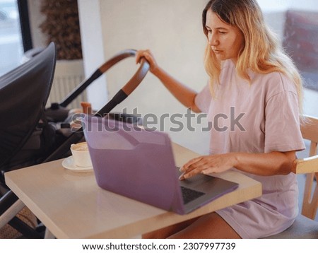 Diverse people portrait. Creative businesswoman balancing work and motherhood. Beautiful young mother working with laptop computer and breastfeeding, holding and nursing her newborn baby at cafe.