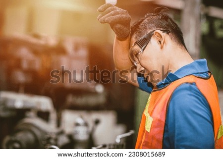 Tired fatigue exhausted engineer feel sick worker from hard working in factory sweat hot bad airflow workplace. Royalty-Free Stock Photo #2308015689