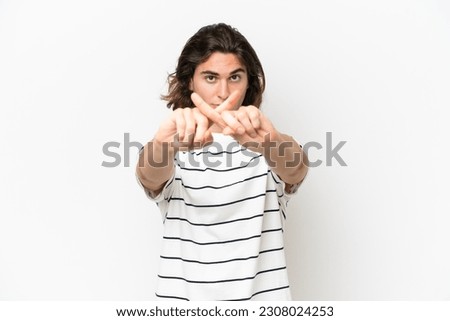 Young handsome man isolated on white background making stop gesture with her hand to stop an act