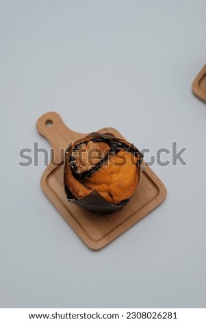 A muffin is a small, sweet baked treat that is usually soft and moist inside, with a slightly crispy exterior. It comes in various flavors and is often enjoyed for breakfast or as a snack.