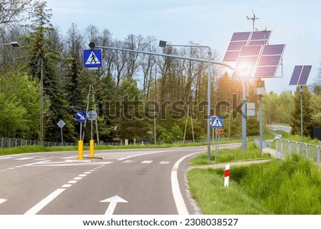 Solar Panel and Windmill Energy on Road with Traffic Light, Road Signs, Pedestrian Crossing. Green energy element on Eco Road. Royalty-Free Stock Photo #2308038527