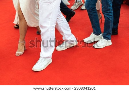 Feet of people walking the red carpet, close up photo