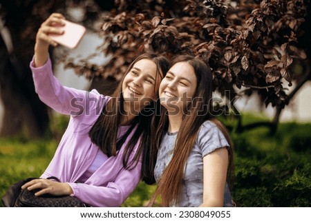 Happy college friends taking selfie together