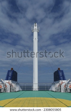 View from Ferry Deck to back of boat and out to sea. Portrait orientation image with copy space set against blue sky.
