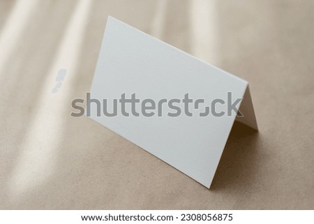 White business card mockup on beige background. Wedding invitation mockup. Name, place, birthday card, thank you card mock up Royalty-Free Stock Photo #2308056875