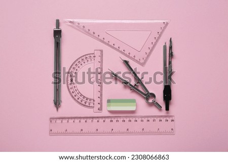 Flat lay composition with different rulers and stationery on pink background