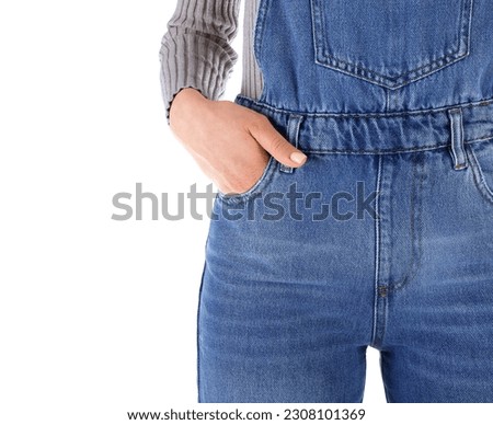 Young woman in denim jumpsuit on white background, closeup Royalty-Free Stock Photo #2308101369