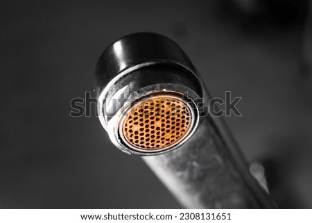 aerator diffuser in the faucet close-up. Corrosion and scale deposits from water. Dirty old water faucet in the washbasin on a blurred background Royalty-Free Stock Photo #2308131651
