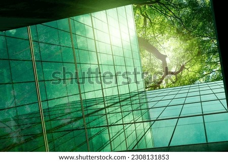 Sustainble green building. Eco-friendly building in modern city. ESG. Sustainable glass office building with green tree. Office with green environment. Corporate sustainability. Net zero emission. Royalty-Free Stock Photo #2308131853