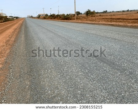 The mixed stone is filled on the road for compaction for CBR bigger than 85% for road work. Royalty-Free Stock Photo #2308155215