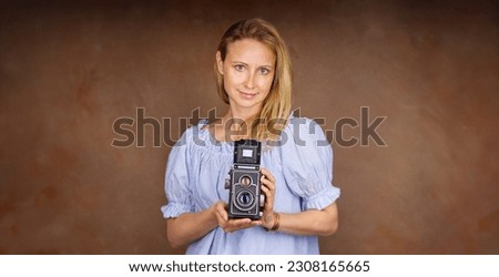  Attractive Woman taking photo with old professional medium format camera 