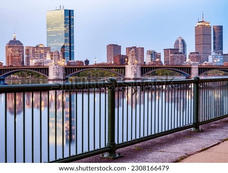 The skyline of Boston in Massachusetts, USA at sunrise showcasing the Charles river and the mix of contemporary and historic buildings.