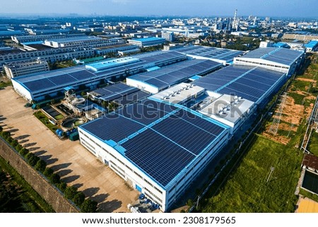 Aerial photography of the solar photovoltaic base built on the roof of the factory building