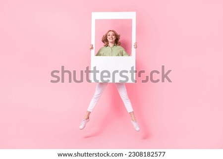 Full length photo of adorable excited lady wear green shirt tacking photo jumping high isolated pink color background