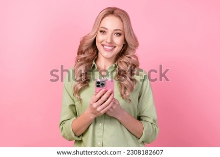 Photo of sweet cheerful woman dressed green shirt communicating iphone modern device isolated pink color background