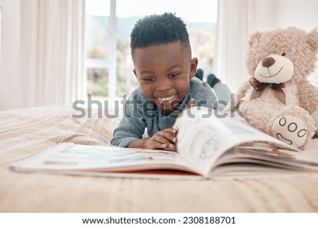 Young african boy, reading and bed for story, book and learning with smile in family home, focus and excited. Black male child, education and relax in bedroom with happiness, study or comic in house