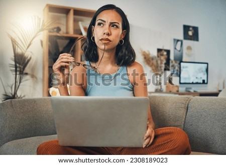 Thinking, laptop and woman Editor doing remote work in her home, apartment or house with an idea working from a sofa. Confused, decision and female person contemplating and planning in a living room