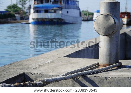 An iron pillar with ropes tied to a pier at Tanjung Emas Harbor in Semarang City in Indonesia