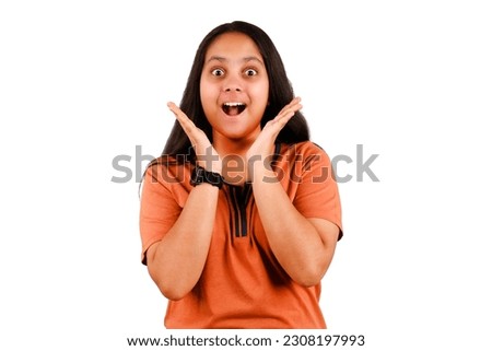 Image of excited young Indian lady standing isolated on white background with copy Space. Looking in camera.
