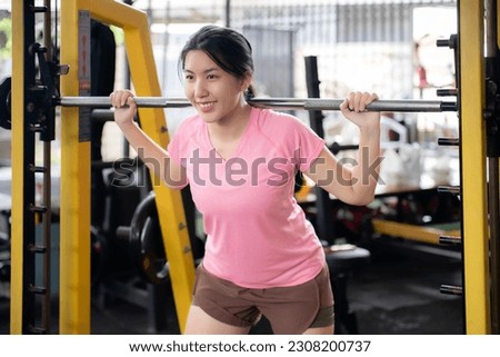 Asian woman exercising to build muscles, toning muscles to keep fit and healthy.Healthcare concept, beginners, self-transformation exercises. Royalty-Free Stock Photo #2308200737