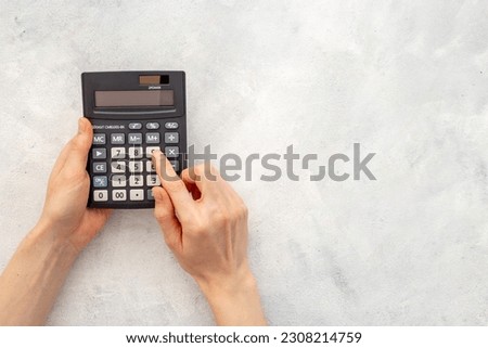 Business accounter working with calculator for taxes accounting.