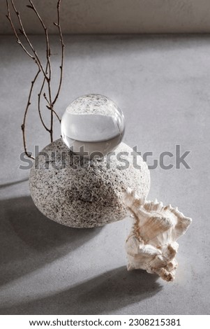 stone, transparent ball and seashell on grey background. still life, abstract organic design concept. calm and relax style. photo for interior. 