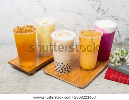 Assorted Fruit iced tea include Passion fruit, Pearl milk, Dragon Cheese Milk, Guava Lemonade iced, Osmanthus Oolong, served in disposable glass isolated on background top view of taiwan drink