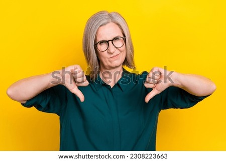 Photo of strict unsatisfied company chief arms fingers demonstrate thumb down disapprove isolated on yellow color background Royalty-Free Stock Photo #2308223663