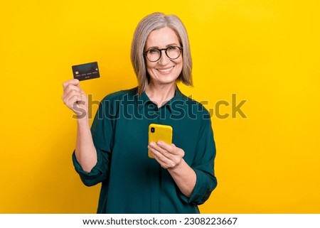 Photo of banker lady check her banking account on internet website with credit card gadget isolated vivid color background