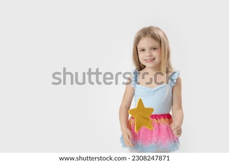 Studio portrait of beautiful little princess holding star shaped magic wand