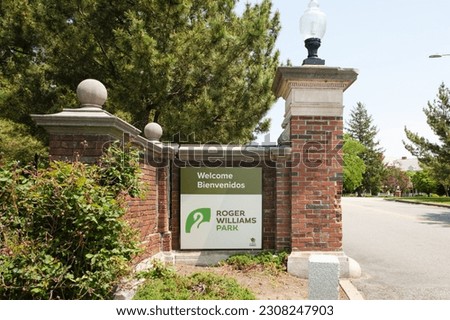 Roger Willams Park brick entrance sign next to road saying Welcome, Bienvenidos, Providence, Rhode Island, USA